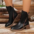 Detailed view of black vintage leather Chelsea boots featuring chunky brown stacked heels - Black
