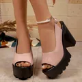 Close-up of pink patent leather peep-toe sandals with chunky black platform heels. - 35 / Lotus Pink