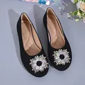 Detail of black square-toe flats with sparkly circular rhinestone buckle embellishment. - 36 / Black