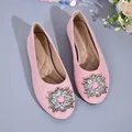 Detail of elegant pink French-style flat shoes with a sparkling circular rhinestone buckle - 36 / Pink