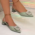 Detail view of light green pointed-toe slingback shoes with a large crystal buckle - 38 / Green