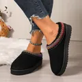 Close-up of black platform slippers with colorful embroidered trim and fur lining. - 36 / Black