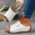 Detailed view of elegant white platform wedge sandals with peep-toe and brand label. - 36 / White