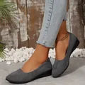 Detail shot of elegant grey suede pointed toe wedge pumps for women on a model - 36 / Gray