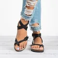 Close-up detailed view of women's stylish black Roman strappy sandals featuring cork soles. - 35 / Black