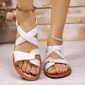 Close-up view of white cross-strap flat sandals featuring comfortable elastic bands - 36 / Roman Style (528#) / White