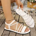 Detail shot of white flat sandals with elegant cross straps and elastic heel. - 36 / Roman Style (52#) / White