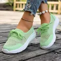 Close-up of mint green breathable mesh slip-on casual shoes for women on wooden deck - Light Green