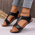 Detail view of black women's platform wedge sandals with hook and loop fasteners. - 35 / Black