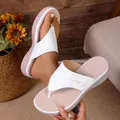 Detailed view of white wedge thong sandals with comfortable thick soles and perforated footbed - 38 / White