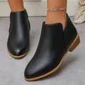 Detail of black pointed-toe leather ankle boots with chunky heel and rear zipper - Black