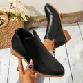 Detailed view of black pointed-toe ankle boots with back zipper and chunky wood-like heel - 36 / Black