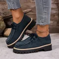 Detailed shot of women's dark blue platform loafers featuring thick lug soles and white stitching. - 36 / Blue