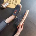 Close-up of blue hollowed-out platform sneakers with multi-color elastic band detail. - 35 / Blue