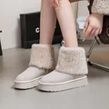 Detailed view of stylish platform snow boots with plush faux fur trim and round toe design - 42 / Off White