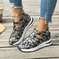 Nahaufnahme von Sandalen mit Blumenmuster, Ausschnitten und weißer Sohle - 36 / Schwarz