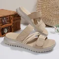 Detailed macro view of beige multi-strap platform sandals featuring textured rope accents - Khaki