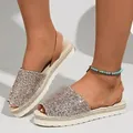 Close-up of sparkly glitter peep-toe flat sandals with comfortable soft soles - Rose Gold