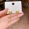 Elegant golden bow dangle earrings with long rhinestone tassels and heart stone - Heart Gem Bowknot Long Tassel (E7134)