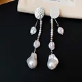 Gros plan de boucles d'oreilles vintage avec métal argenté martelé et perles baroques - Argent