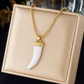 Detailed macro view of a white faux horn pendant on a gold ball chain necklace - White Ox Horn Pendant Style (N4585)