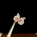 Exquisite silver-toned open ring featuring a pink zircon butterfly design with pavé accents. - Silver-Pink
