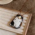 Detailed close-up of handcrafted embroidered cat pendant on a minimalist cord necklace - Embroidered Black and White Kitten Necklace / Coffee Cord with Black and White Cat