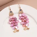 Vue détaillée des boucles d'oreilles poisson rose avec des pompons en écailles d'or. - 36# Style Crochet d'Oreille (Gland en Forme de Poisson Rose) / Rose