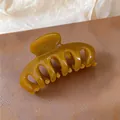 Close-up of a stylish amber acrylic hair claw clip designed for elegant hairstyles and updos - Amber