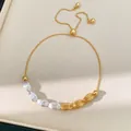 Detailed view of vintage gold and silver oval textured beads on a pull-type bracelet - Gold and Silver Two-tone
