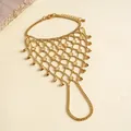 Detailed view of a gold-tone mesh finger bracelet with geometric discs and fringe. - Round Sunburst Style / Gold