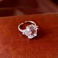 Close-up of elegant open ring featuring a large pink oval zircon and clear side stones. - Oval Zirconia Open Ring / Silver-Pink