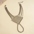 Close-up of silver-colored metal bead hand chain with intricate mesh and tassel design - Hollow Mesh Style / Silver
