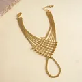 Close-up view of an intricate gold-toned multi-strand bead chain slave bracelet hand harness. - Hollow Mesh Style / Gold