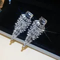 Macro view of luxurious fan-shaped pendant earrings with brilliant clear rhinestones - White Rhinestone
