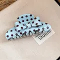 Detail view of a light blue retro polka dot bow hair claw clip for women's styling. - Polka Dot Bow Hair Claw / Green