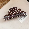 Close-up of retro brown hair claw clip with cream polka dots and an elegant bow detail - Polka Dot Bow Hair Claw / Brown