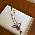 Close-up of cute bear pendant necklace with brown Korean velvet cord on display - Teddy Bear / Brown