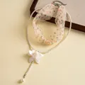 Close-up detail view of elegant pearl necklace with white resin flower and ribbon - White (Multicolor Polka Dot)