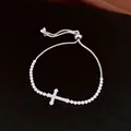 Close-up of adjustable silver-toned bracelet with sparkling zircon cross pendant. - Style 2 (HB7045) / Silver