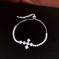 Close-up of elegant cubic zirconia cross pendant on adjustable silver-toned bracelet - Style 5 (WB1998) / Silver