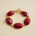 Elegant vintage gold-toned toggle bracelet featuring five faceted oval red resin stones - Red