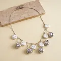 Close-up detail of retro metallic wrinkled beads and white baroque pearl fringe necklace - Necklace / White Eco-Friendly Pearl / Silver