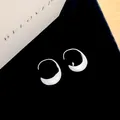 Detailed view of silver crescent hoop earrings with brushed metal finish on black velvet - Earring Hooks - Silver