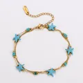 Detail view of gold stainless steel double-layer bracelet featuring blue starfish charms - Blue-Green Starfish (Starfish Style 1) / 17+5cm