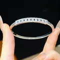 Detailed macro view of 18K gold plated silver bangle encrusted with sparkling zircon stones - Geometric Hollow Style (10#) / Silver