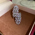 Detailed view of a sparkling zircon hollow geometric open ring inside a jewelry gift box - Wing Geometric Style / Silver
