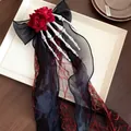 Detailed view of Gothic Halloween hair clip with skeleton hand, red roses and black bow - Duckbill Clip Style / Red-Black