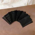 Dettaglio della texture degli adesivi magici neri per capelli per fissare le ciocche - 5 Pezzi / Nero