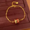 24K gold plated bracelet with red and black enamel charm and cubic zirconia accents - Bracelet / Gold-Red